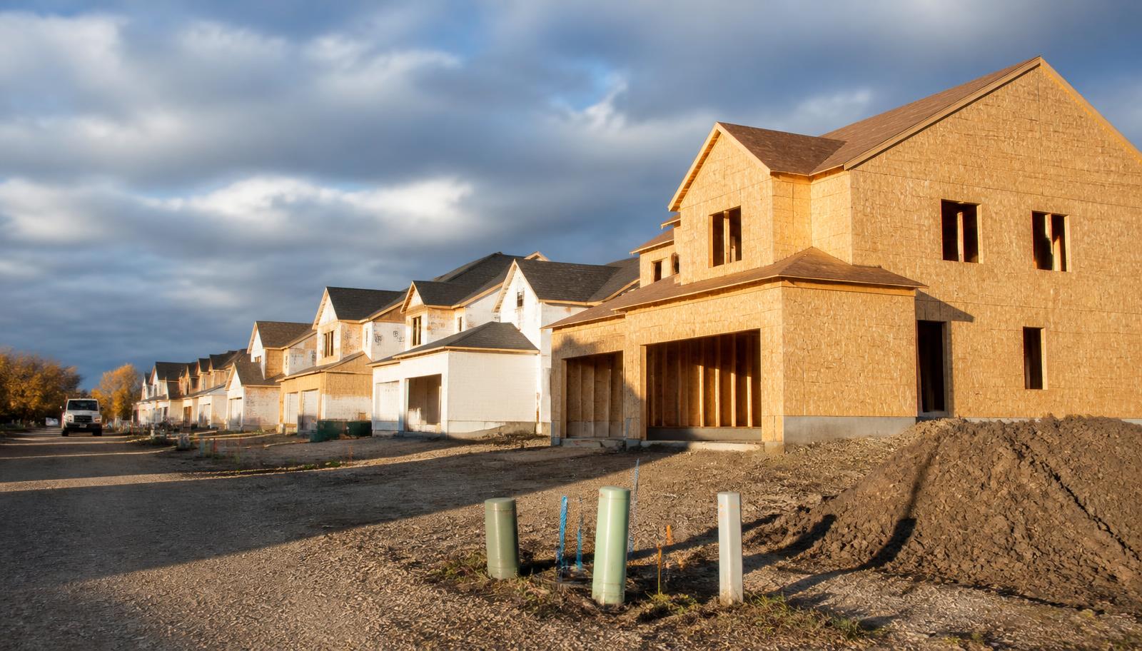 Wood-framed homes under construction in a new Central Minnesota subdivision